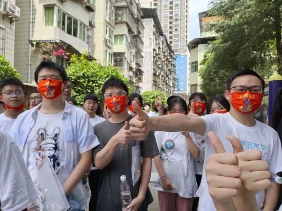 走出考场的四川省通江县涪阳中学考生开心地竖起了大拇指，互相鼓励继续加油。