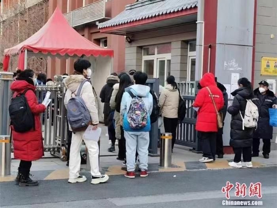 资料图：2023年国考北京一考点外，考生正在排队进入考场 刘欢 摄