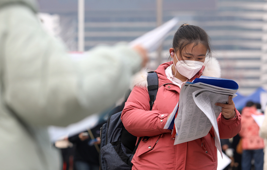 2月18日，在河北省艺术中心文化广场，求职者在翻阅招聘信息，寻找工作机会。梁子栋 摄新华社发